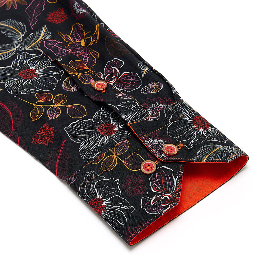 Floral-patterned fabric shirt sleeve cuff detail with red buttons 