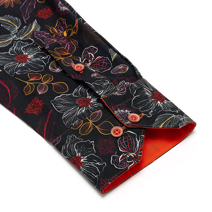 Floral-patterned fabric shirt sleeve cuff detail with red buttons 