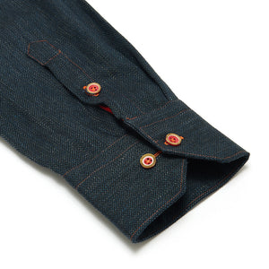 
            
                Load image into Gallery viewer, Close-up of a dark denim shirt sleeve with red buttons on a white background
            
        